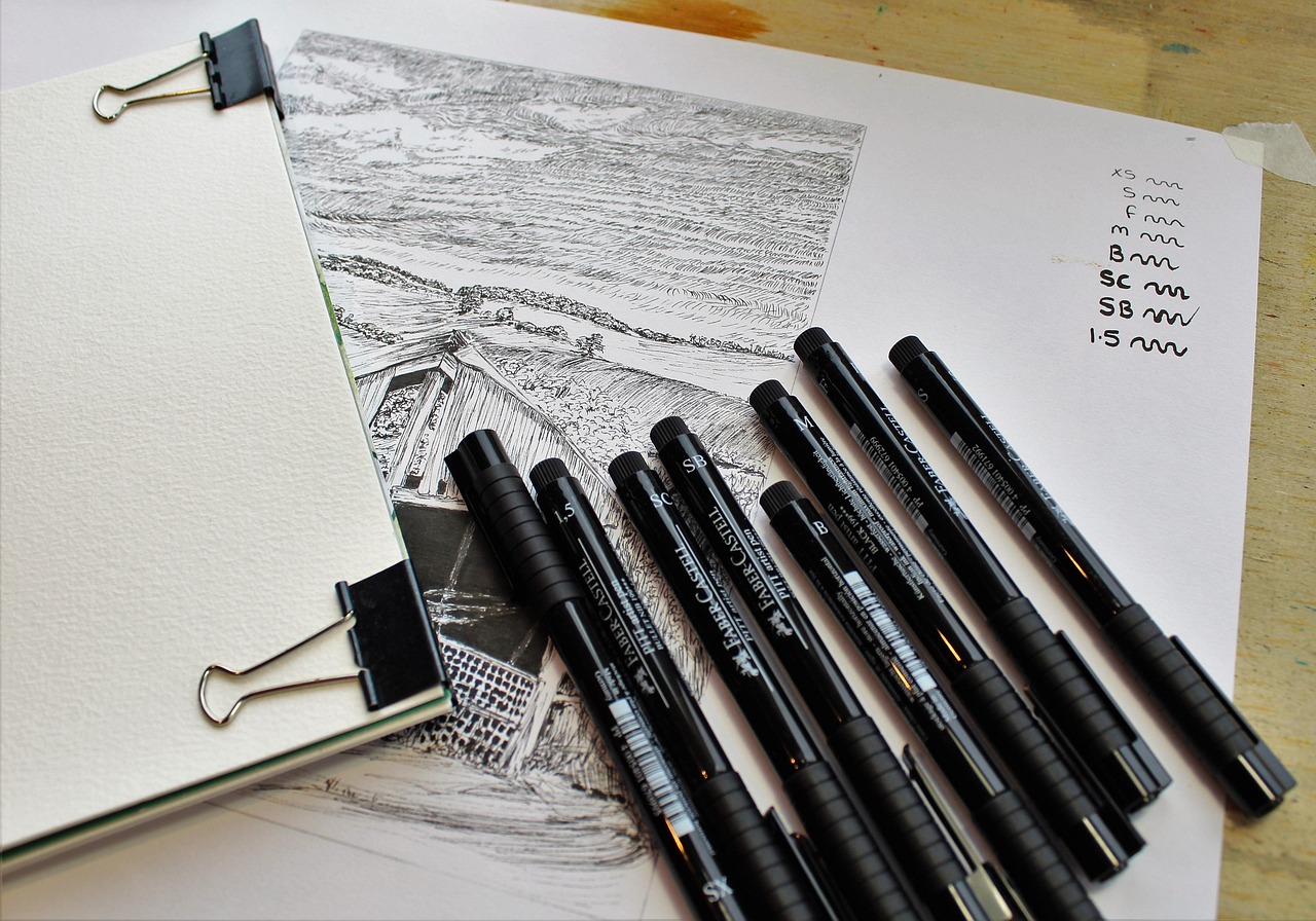 Pen drawing in progress with a row of fineliners